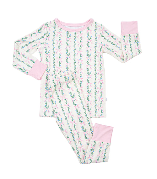 Children's bamboo pajama set with bows and floral pattern on a white background